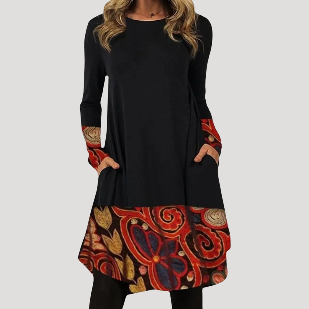 Dam långärmad tunikaklänning med mönstrad nederdel och fickor stilren